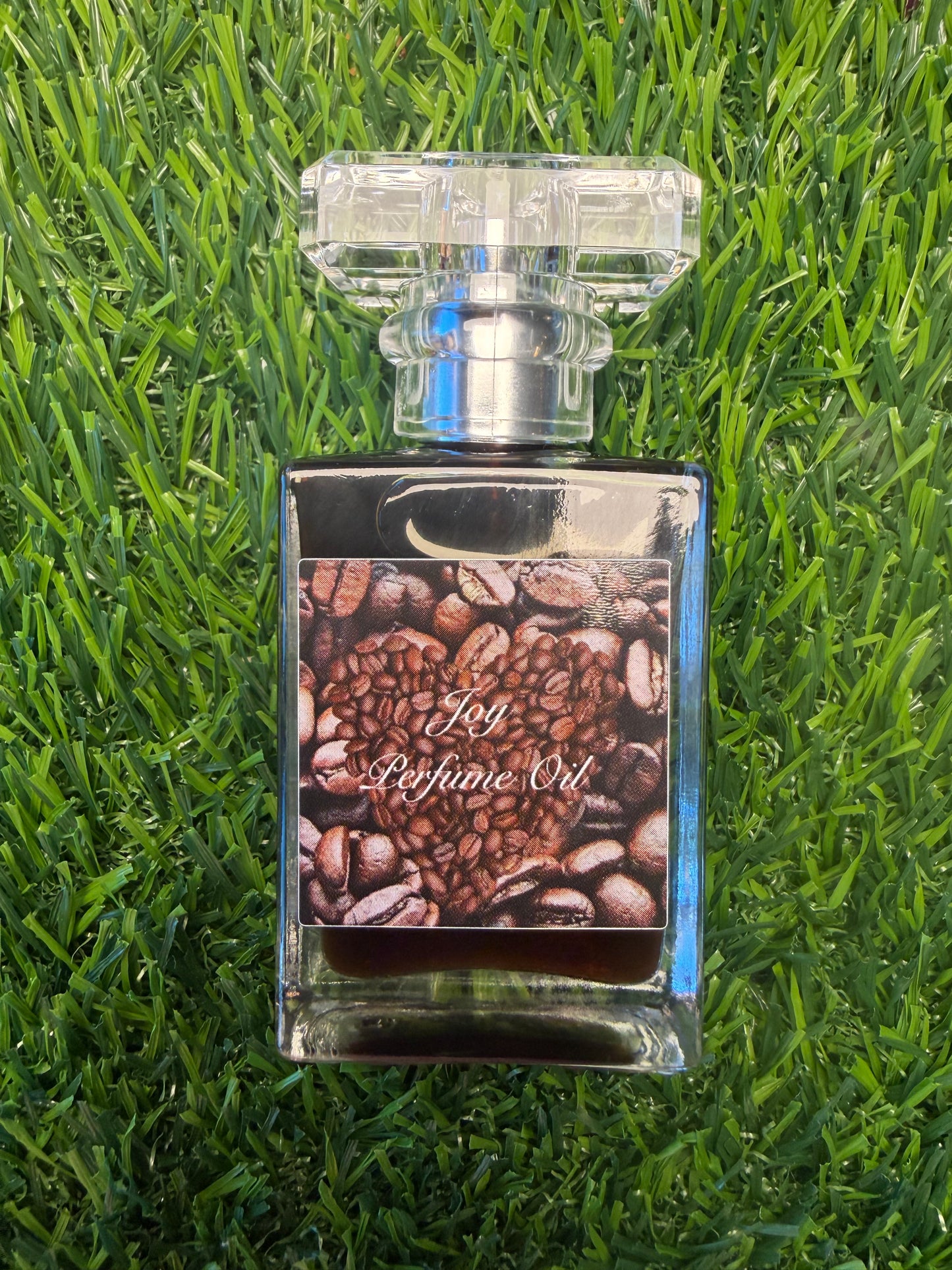 Joy perfume oil by LOVE BY EMMASKINCARE with sweet coffee and cardamom scent, showcasing the bottle and fragrance details.