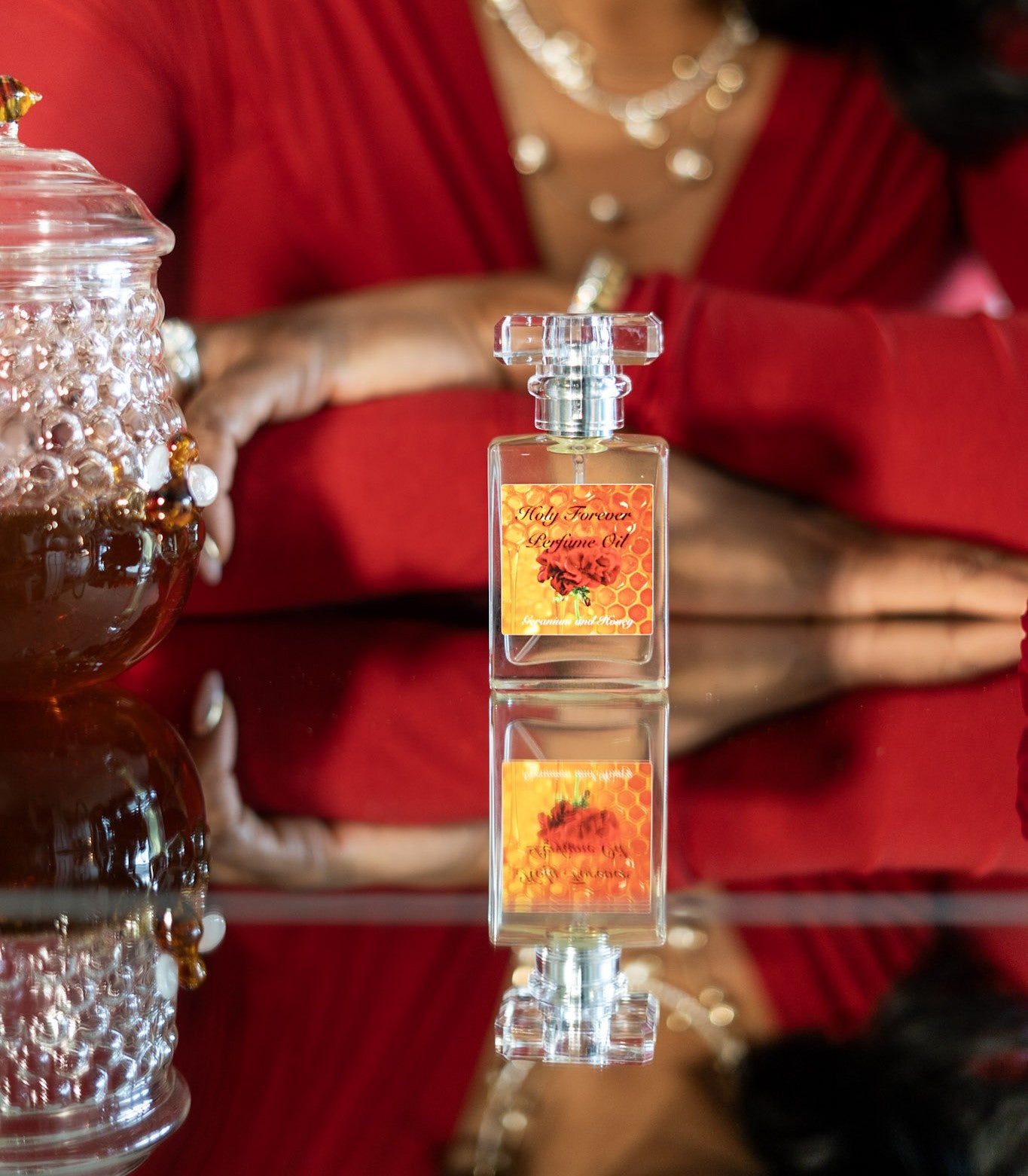 Holy Forever Perfume Oil by LOVEBYEMMASKINCARE with sweet honey and geranium scent, shown in a glass bottle with floral accents.