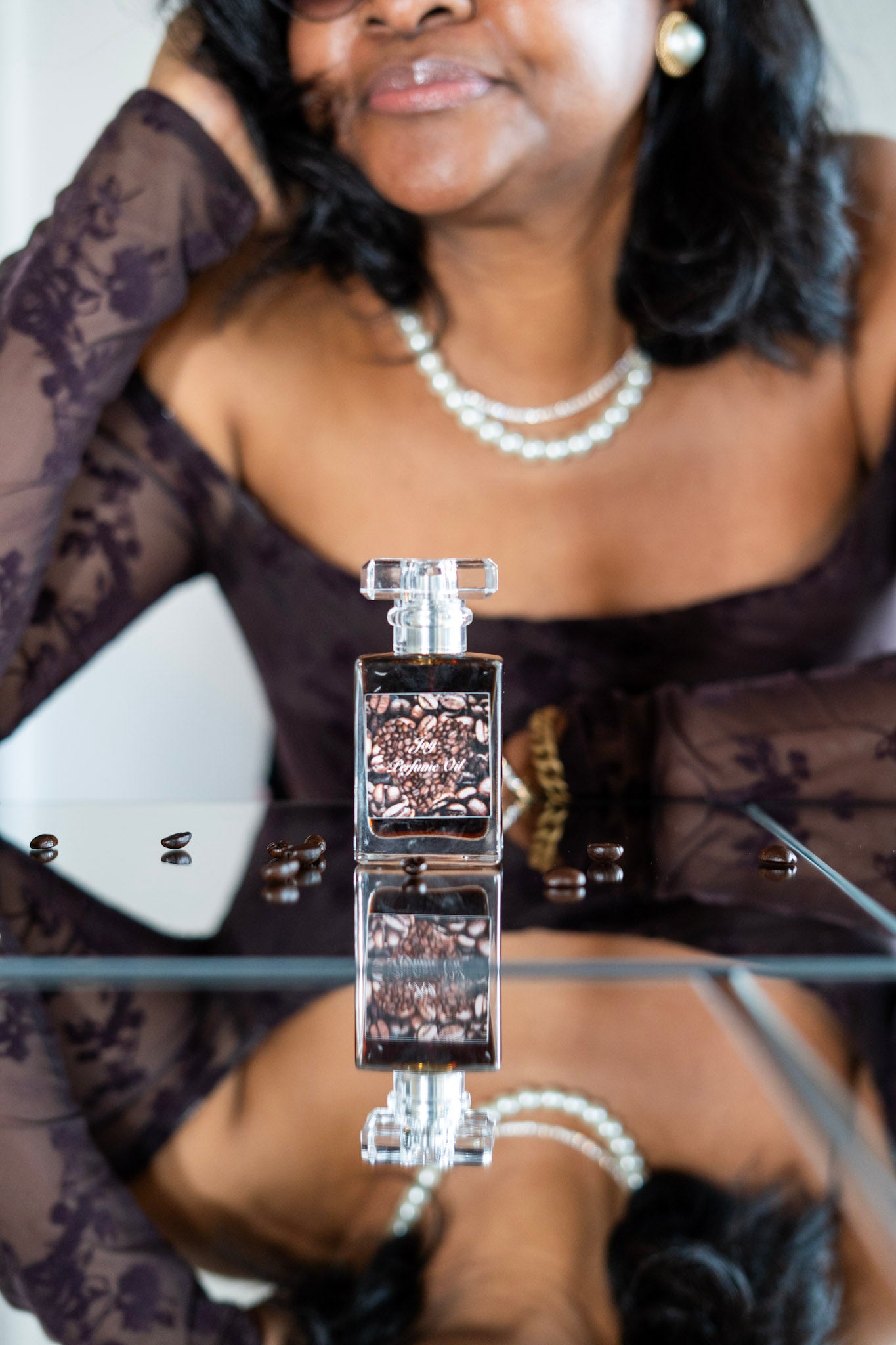Joy Perfume Oil by LOVEBYEMMASKINCARE featuring a sweet coffee and cardamom scent in a sleek glass bottle.