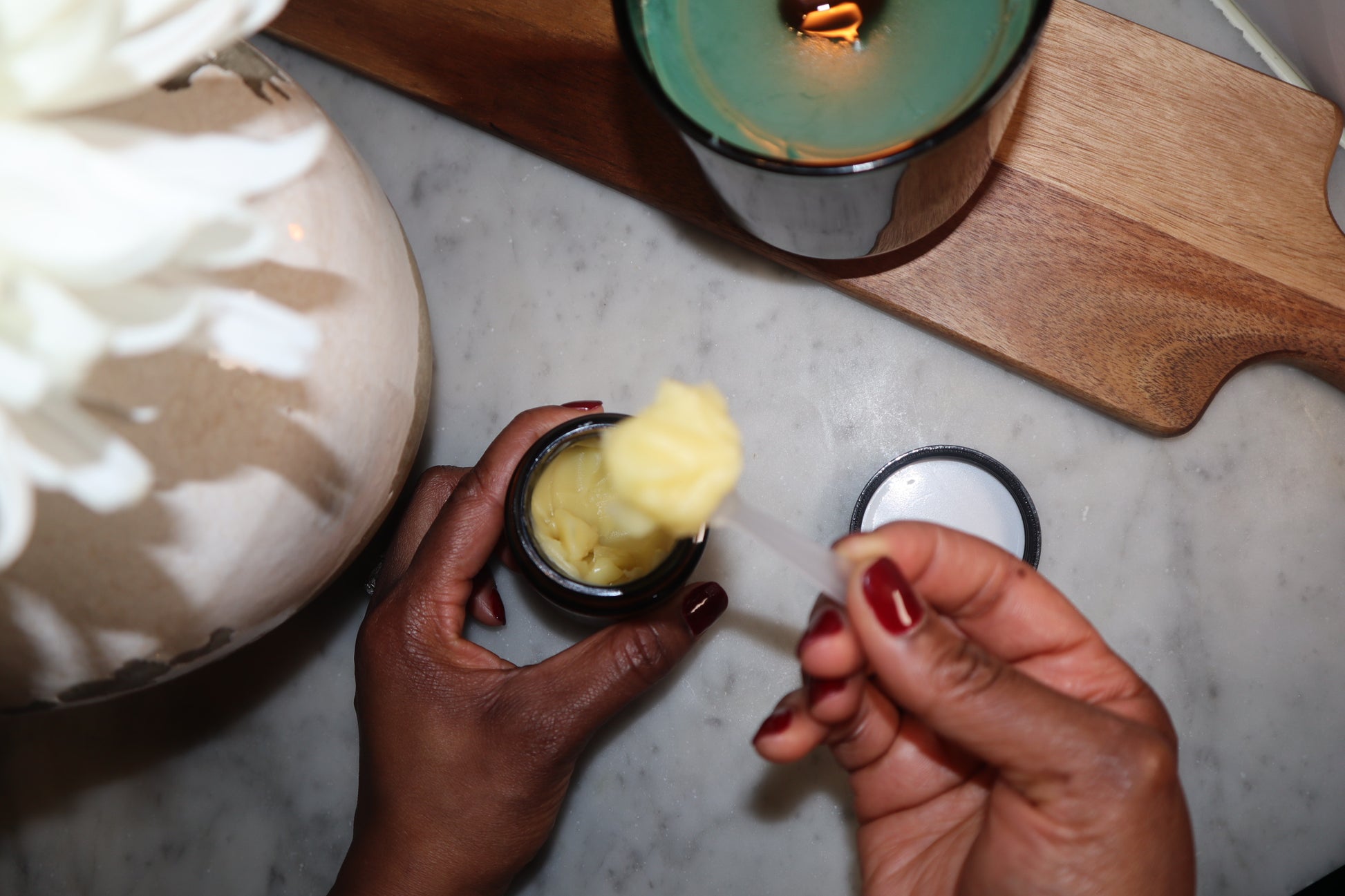 Nourishing balm for face, neck, and hands in a 2oz jar, designed to hydrate and improve skin elasticity.
